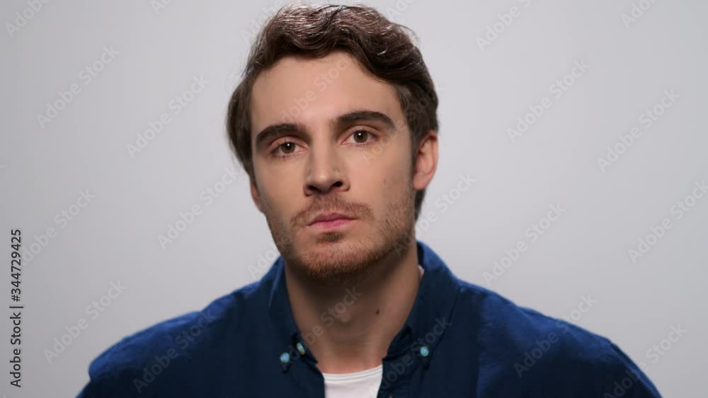 Angry man looking at camera. Displeased guy gesturing with hands in studio Angry man looking at camera. Displeased guy gesturing with hands in studio