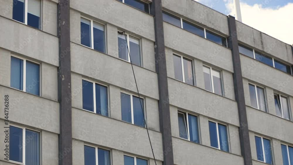 Long pole operated by man cleans window surface with wet doam brush Long pole operated by man cleans window surface with wet doam brush