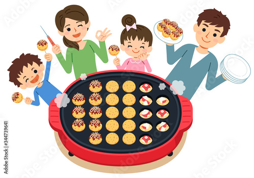 家族で料理　ホットプレートでたこ焼きを焼く
