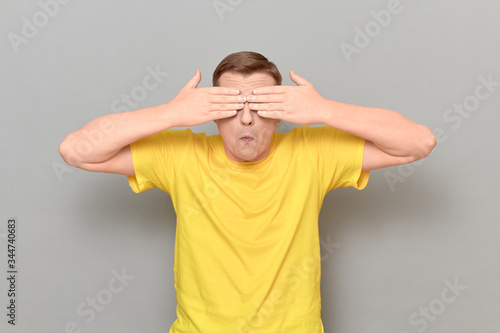 Portrait of man covering eyes with hands