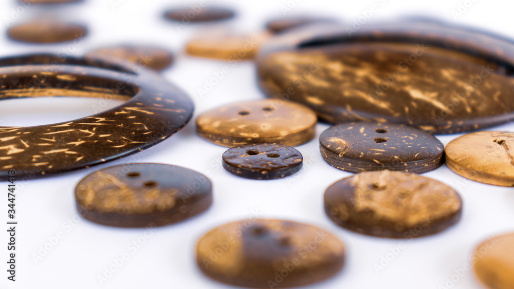 Coconut shell buttons spreads across white background Coconut shell buttons spreads across white background