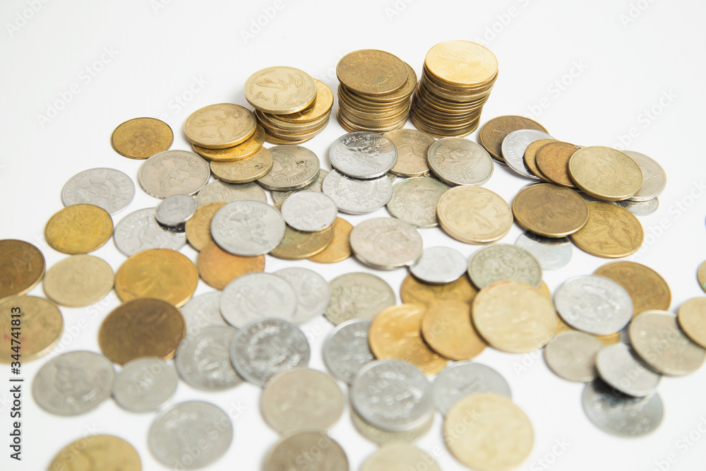 Coins stacked in small towers - Coins isolated from white background - Pile of queztales currency of Guatemala Coins stacked in small towers - Coins isolated from white background - Pile of queztales currency of Guatemala