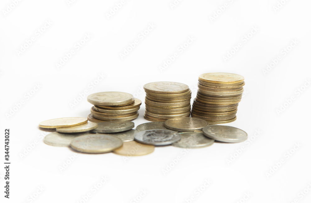 Coins stacked in small towers - Coins isolated from white background - Pile of queztales currency of Guatemala Coins stacked in small towers - Coins isolated from white background - Pile of queztales currency of Guatemala