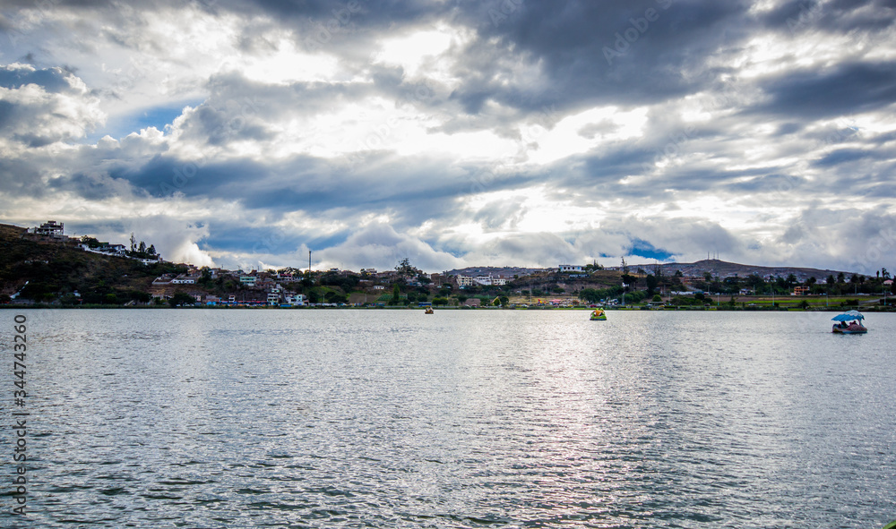 View of the Yahuarcocha lake, with a panoramic view of the city in the horizont in Yahuarcocha Ecuador View of the Yahuarcocha lake, with a panoramic view of the city in the horizont in Yahuarcocha Ecuador