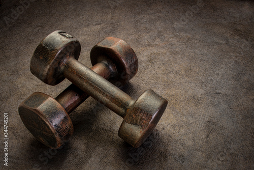 old rusty dumbbells - fitness and exercise concept