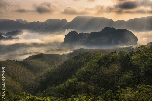 Scenic view of mountain and mist at sunrise.