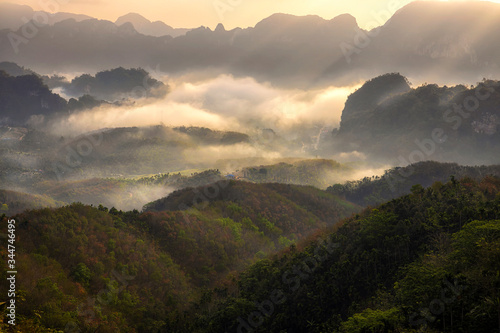 Scenic view of mountain and mist at sunrise.
