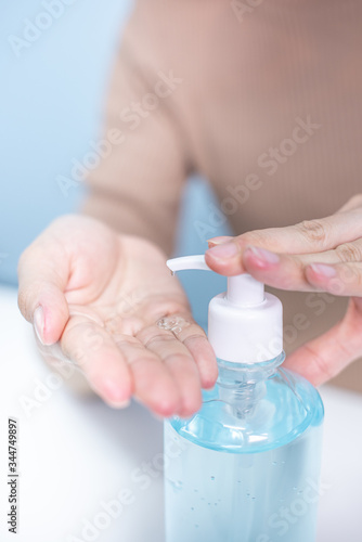 woman hands using alcohol gel for protect corona virus and bacteria, cleaning virus, healthy, covid-19, tree background, quarantine concept.
