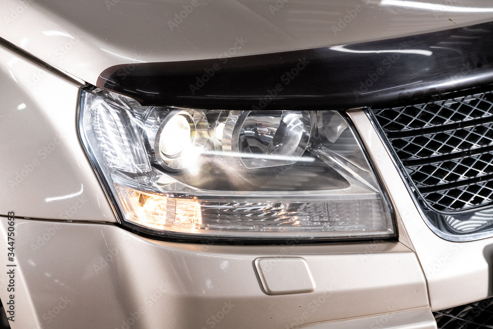 Beauty clean headlights of beige SUV. close up  of modern  car xenon lamp headlight.