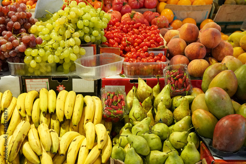 Fototapeta Naklejka Na Ścianę i Meble -  Fruits display (Banana,Pear,Mango,Peach,Grape)  in BArcelona market