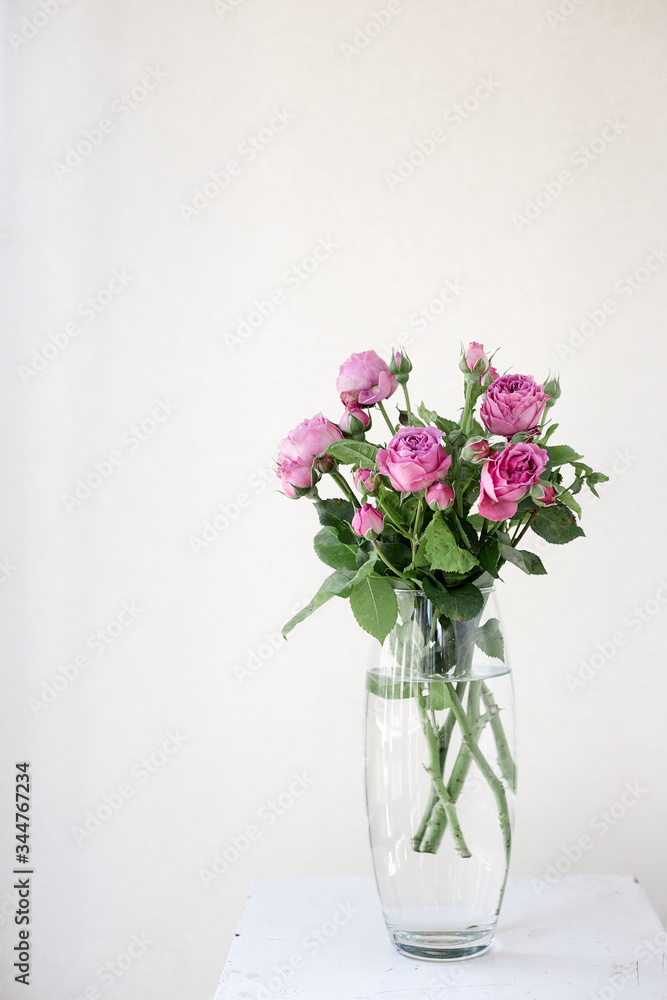 A vase filled with purple flowers with background