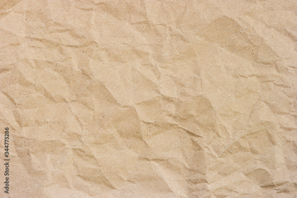Fototapeta premium Brown crumpled paper texture background with space for design.