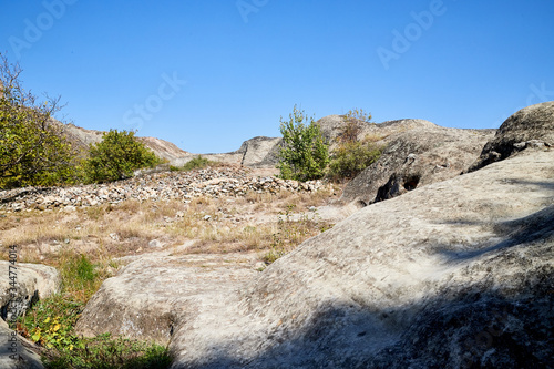 Rocks, stones, stone in the mountain reserve and blue sky on a summer day. Uplistsikhe city in Georgia, Europe