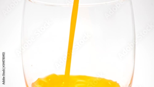 orange juice drop in glass slow motion