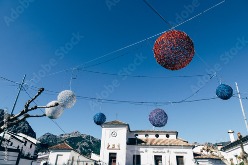 Giant christmas toys decorating streets of mediterrainian old medieval town with white buildings photo