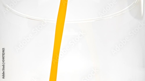 orange juice drop in glass slow motion