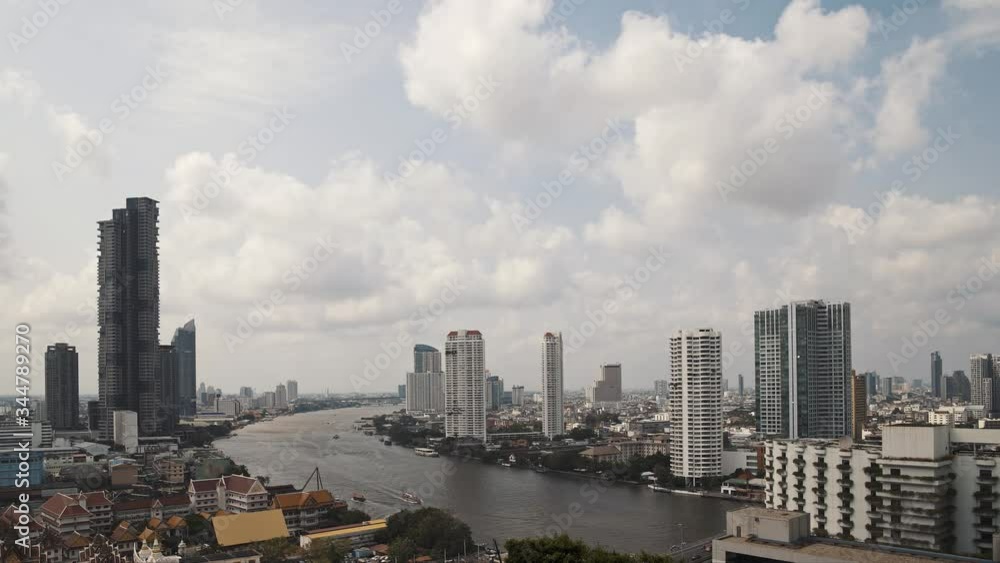 Locked down real time establishing shot of cityscape of Bangkok. Bangkok is the capital of Thailand. Traffic on the Chao Phraya river in Bangkok, Thailand. Locked down real time establishing shot of cityscape of Bangkok. Bangkok is the capital of Thailand. Traffic on the Chao Phraya river in Bangkok, Thailand.
