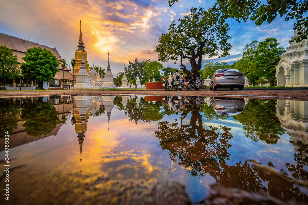 CHIANG MAI, THAILAND - APRIL 28, 2020 : Wat Suan Dok Temple reflection in twilight, is a Buddhist temple and Royal Temple of the Third Class in Chiang Mai  Thailand. Landmark of Chiang mai.