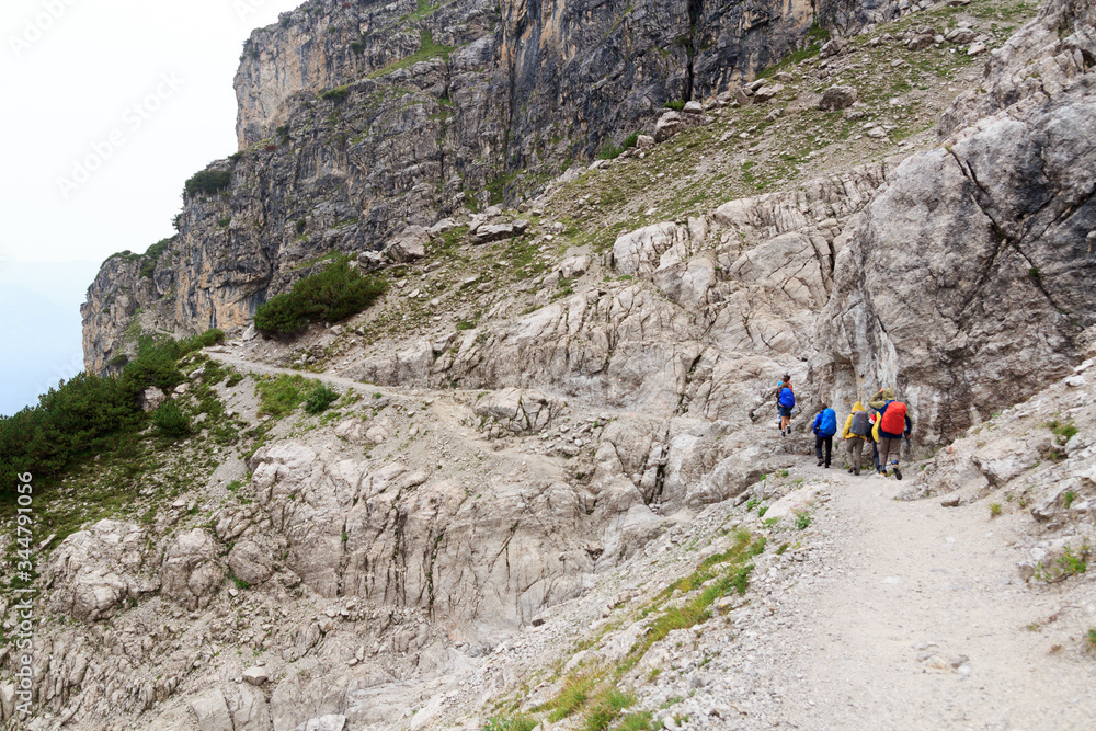Obraz premium People hiking in Brenta Dolomites mountains during rain, Italy