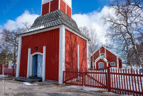 Jukkasjarvi Church, a Wooden red-colored church with a stand-alone bell tower in Swedish Lapland near Kiruna. photo