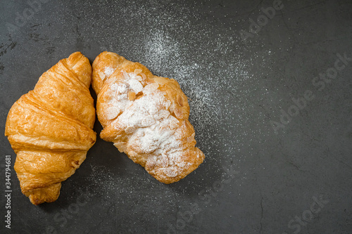 Fresh croissant on a black slate background. Top view . Copy space