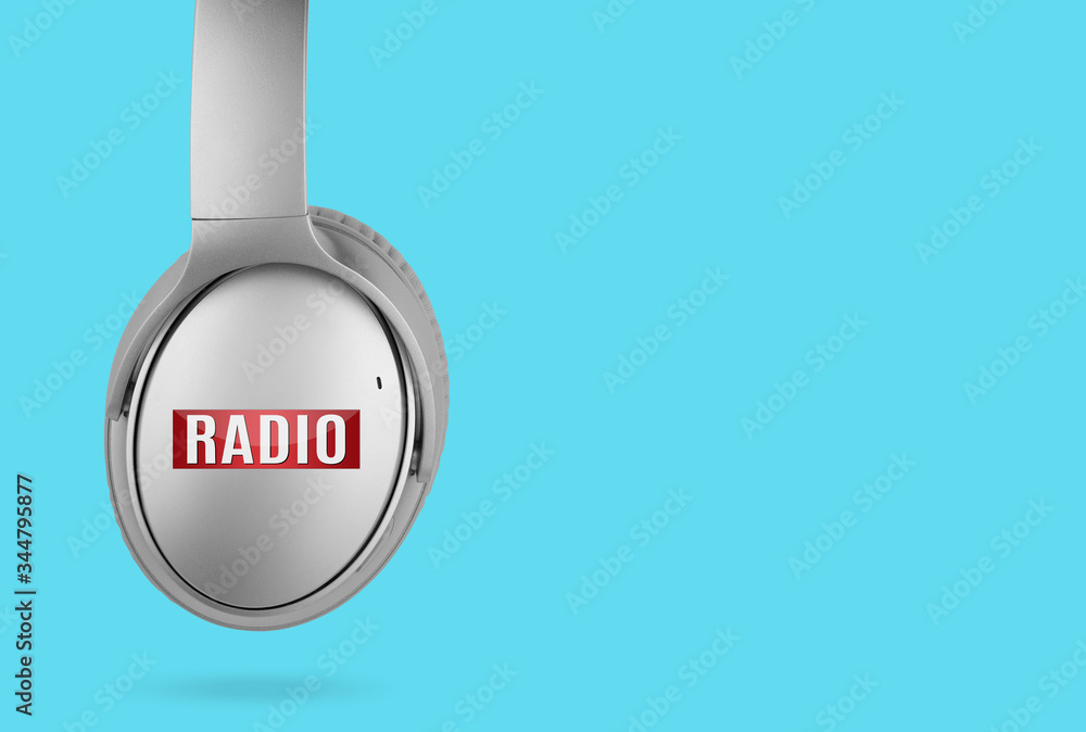Modern headphones with radio icon isolated on blue background Modern headphones with radio icon isolated on blue background