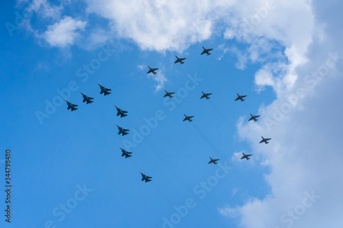 A group of professional pilots of military aircraft in sky. 