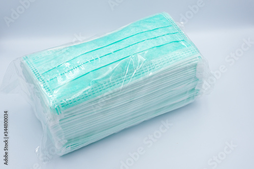 Green face mask pack for wholesale isolated on white background - COVID19 protection concept