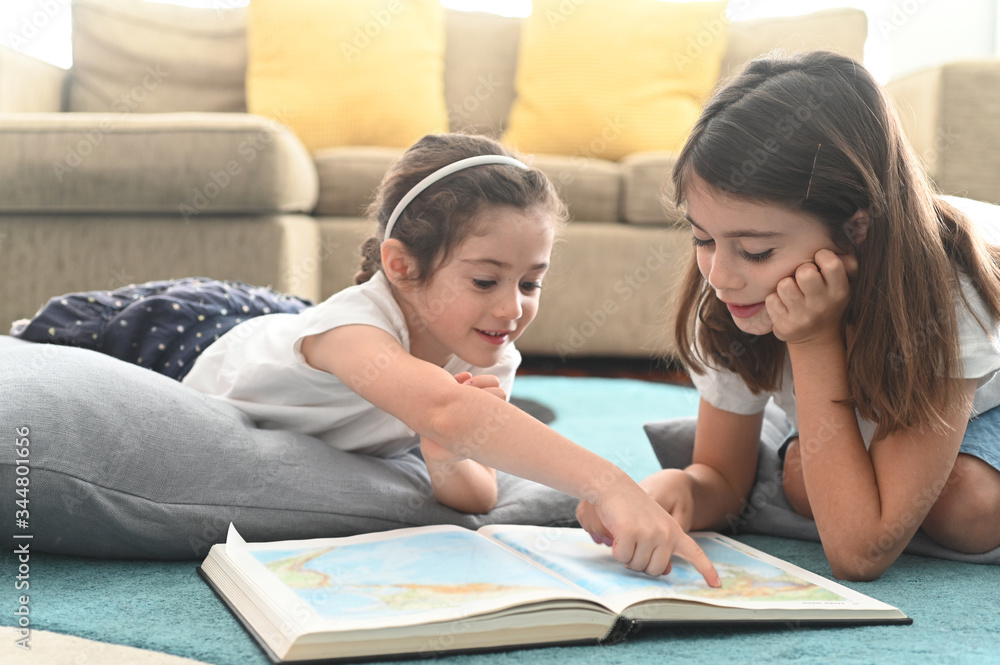 Fototapeta premium Girls reading a book together