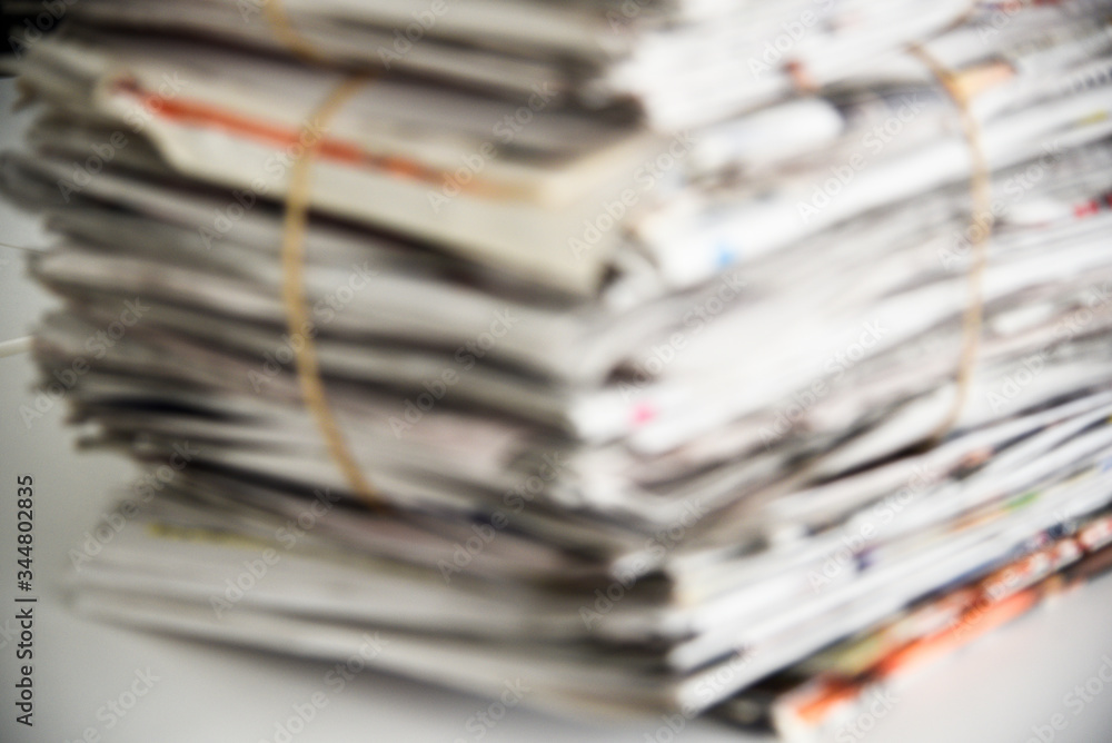 Blurred a pile of newspaper, background texture. Lots of retro journals with headlines, articles and photos Blurred a pile of newspaper, background texture. Lots of retro journals with headlines, articles and photos