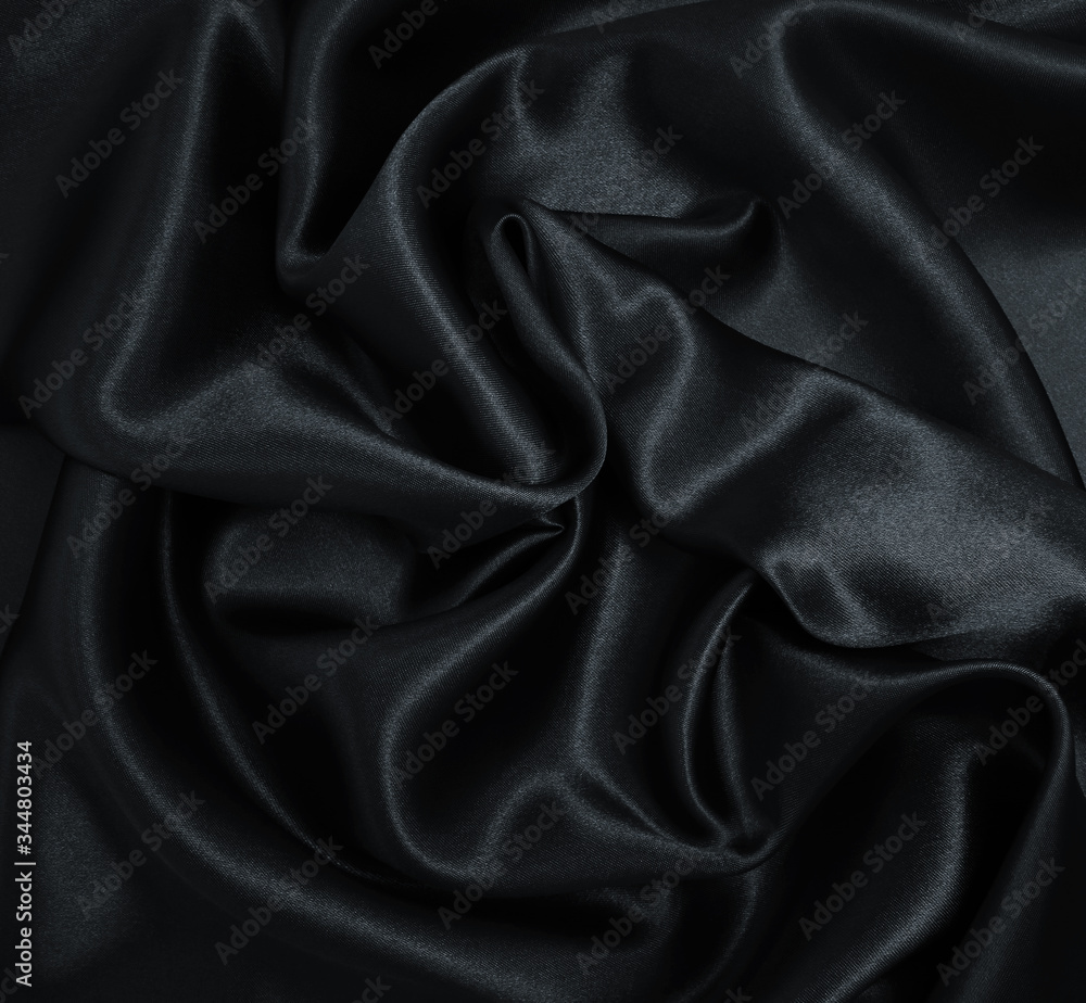 Fototapeta premium Smooth elegant black silk or satin texture as abstract background. Luxurious background design