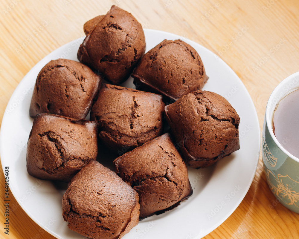 Сhocolate cupcakes on a white plate prepared at home Сhocolate cupcakes on a white plate prepared at home