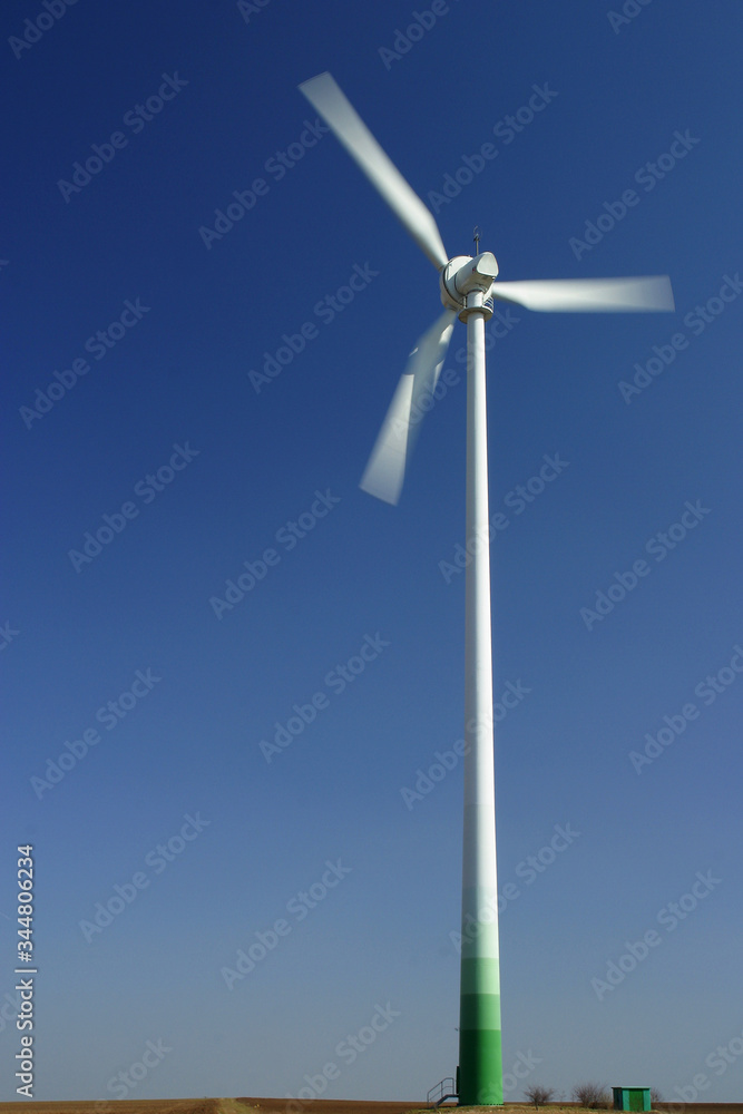 Wind turbines generating power on green field Wind turbines generating power on green field