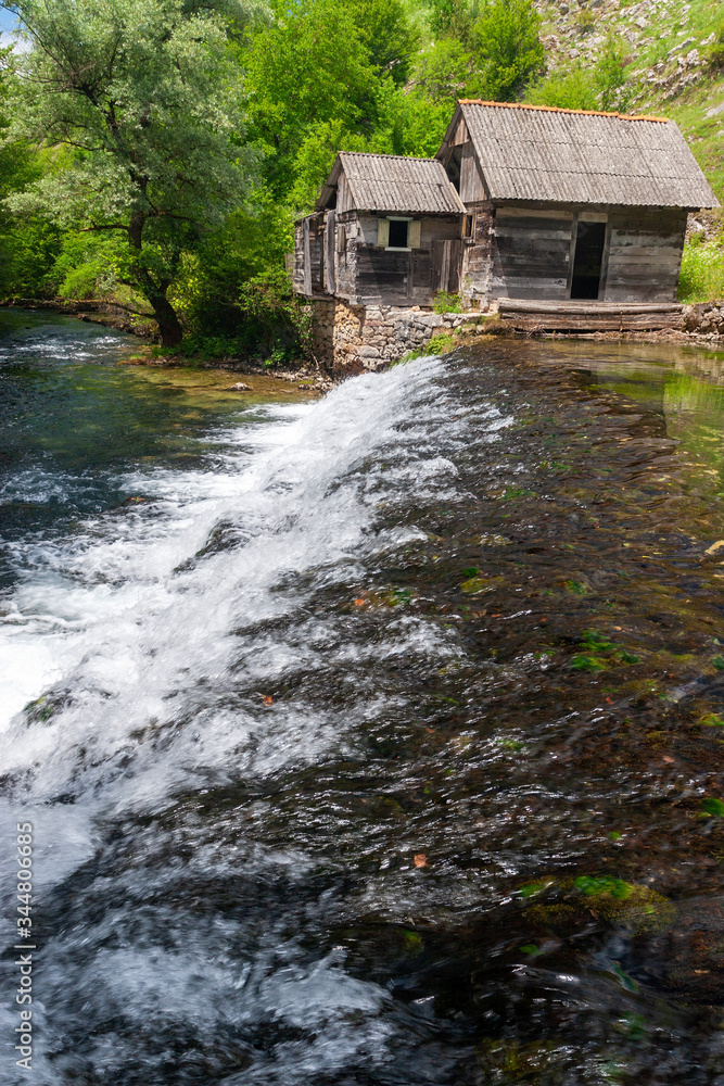 Old mill and the waterfall on the Slunjcica River source in Croatia Old mill and the waterfall on the Slunjcica River source in Croatia