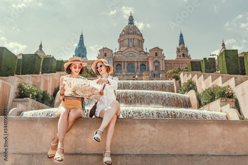 Photography Two girlfriends are looking at a map of attractions in Barcelona and Spain