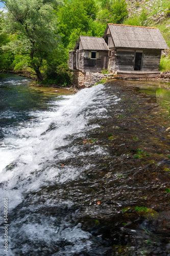 Old mill and the waterfall on the Slunjcica River source in Croatia
