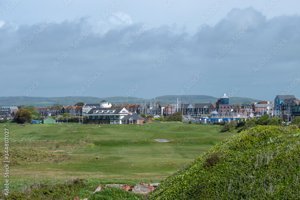 View from the sand dunes looking along the fairway of the first hole towards the Littlehampton golf clubhouse during lockdown in England. View from the sand dunes looking along the fairway of the first hole towards the Littlehampton golf clubhouse during lockdown in England.
