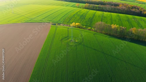bird eye view onto electrical transfer rack standing in the green field under the sun