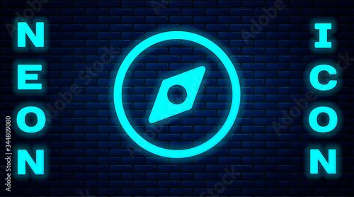 Glowing neon Compass icon isolated on brick wall background. Windrose navigation symbol. Wind rose sign. Vector Illustration