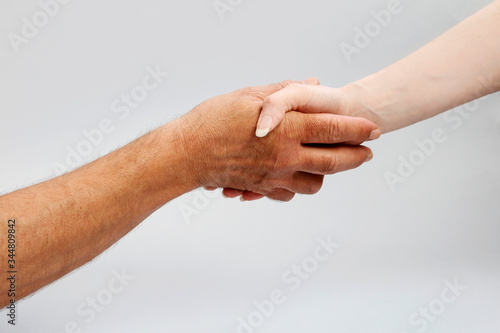 The woman and the man are shaking hands.