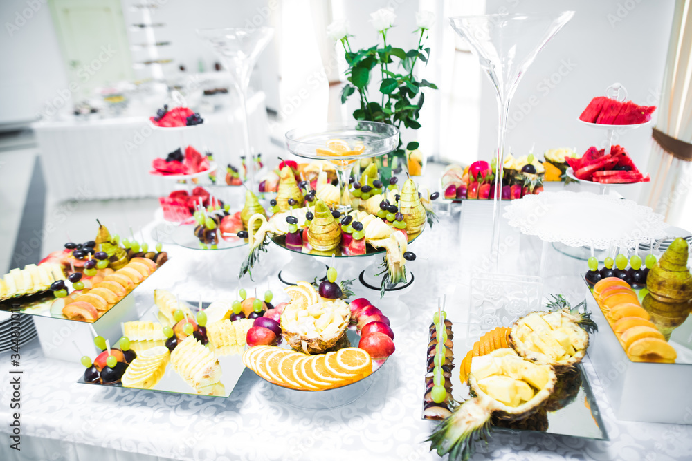 Delicious and tasty dessert table with cupcakes and shots at reception closeup