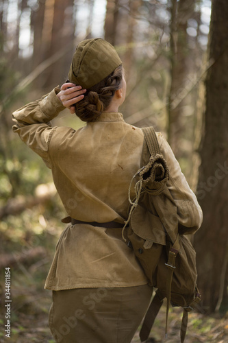 girl in uniform in the forest with a backpack