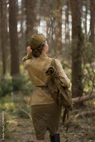 girl in uniform in the forest with a backpack