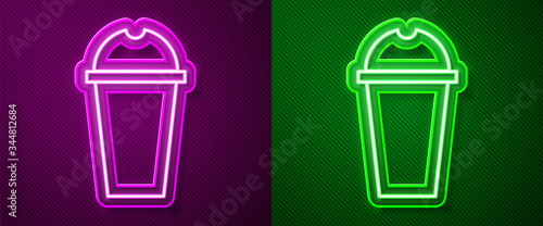 Glowing neon line Milkshake icon isolated on purple and green background. Plastic cup with lid and straw. Vector Illustration