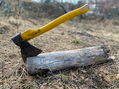 Hatchet Ax and Pile of Split Wood Logs for Fire, Selective Focus with Shallow Depth of Field, Toned Image.