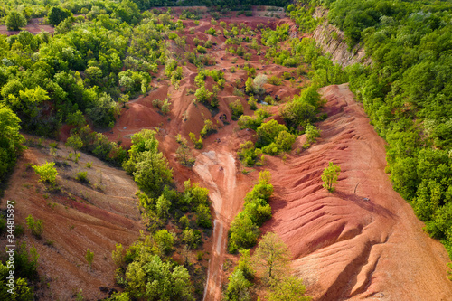 Hungary Gant. Abandocned Bauxite mine. Planet Mars mood. orange and red colors on the  ground everywhere. Apocaliptic sight. photo