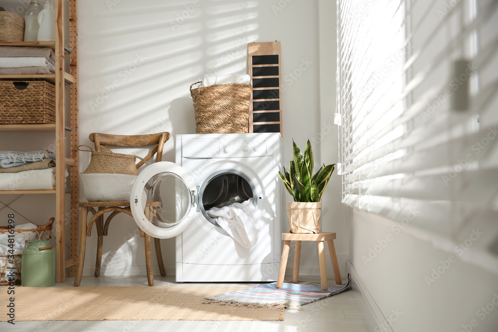 Modern washing machine in laundry room interior - obrazy, fototapety, plakaty 