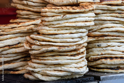 Stack of home made pita bread for sale at a fast food restaurant at a street food market

