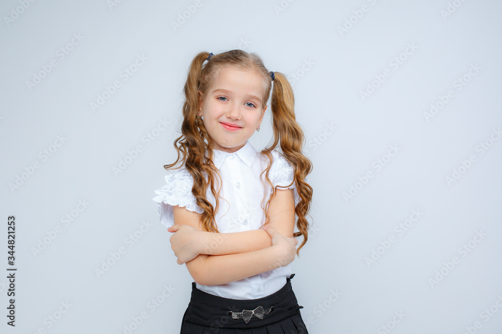 a little girl in school uniform holds a globe in her hands on a white background a little girl in school uniform holds a globe in her hands on a white background