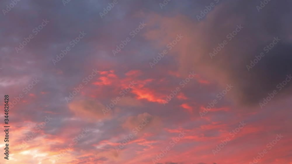 Red clouds in the setting sun run across the dark magnetic sky.